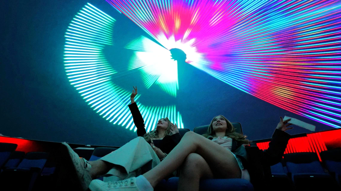 two young women in flandrau planetarium at a laser show